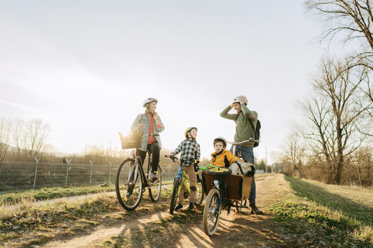 family biking together safely to avoid having to use insurance coverage due to an accident