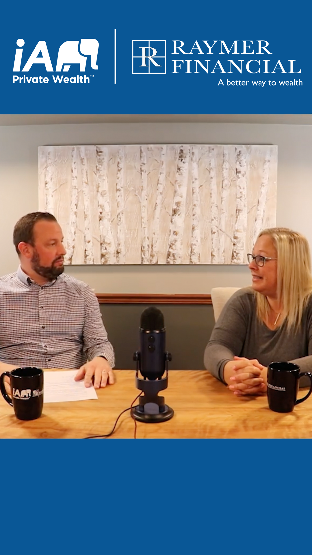 Ryan Husk and Barb Wilhelm sitting at a desk with a microphone in front of them recording their conversation about whether you should refinance your mortgage