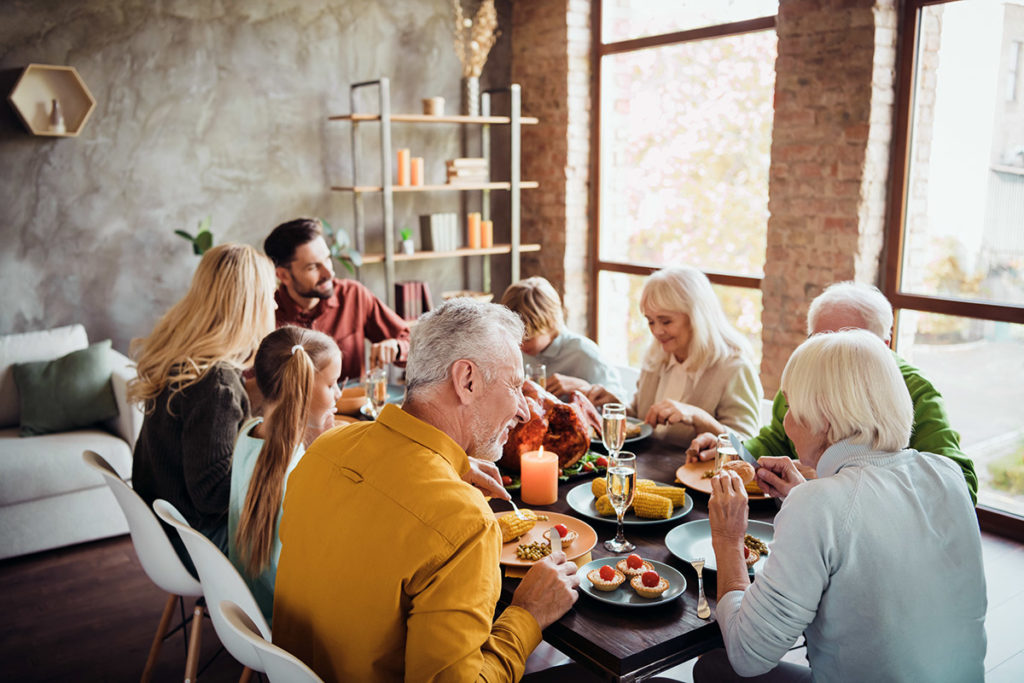 Portrait of nice lovely idyllic cheerful big full family brother sister couples eating tasty yummy meal dishes feast gratefulness autumn fall season in loft brick wood industrial style interior house