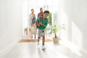 happy family entering front door of their first home